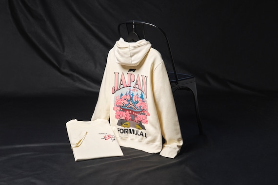 As Formula One heads to Japan for the 2025 Japan Grand Prix, get yourself ready for the main event with this official apparel celebrating Japanese culture and design. A Sakura branch sits on the chest with both English and Japanese script while the back features artwork of a traditional Shinto temple and Suzuka text, the venue for what’s sure to be a memorable third round of the 2025 F1 season.